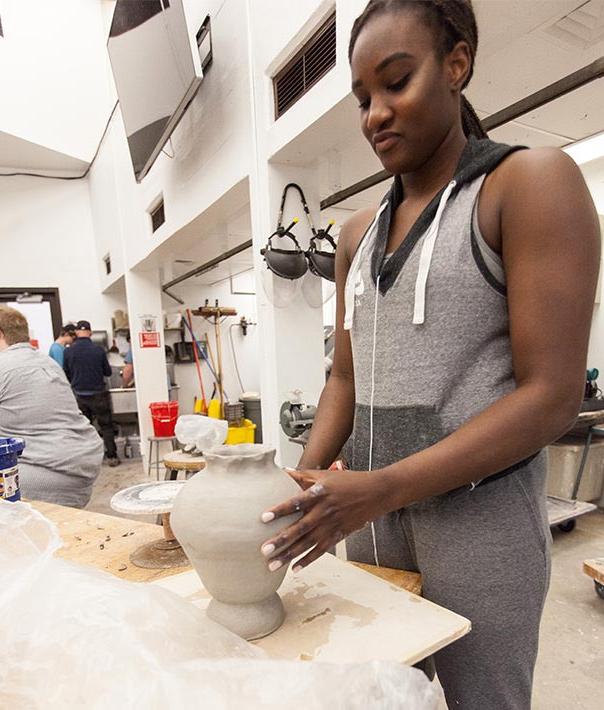 image of art student working with clay